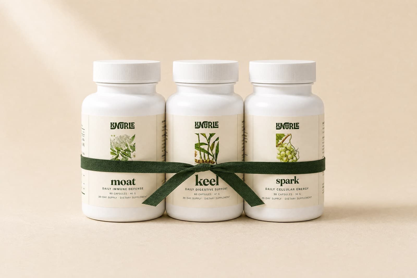 Moat, Keel and Spark tied together with a green ribbon
